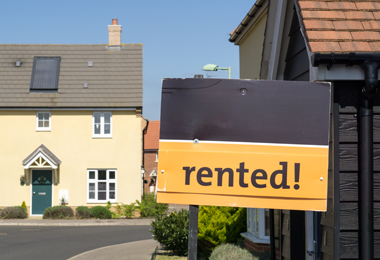 rented sign ourside house in a street