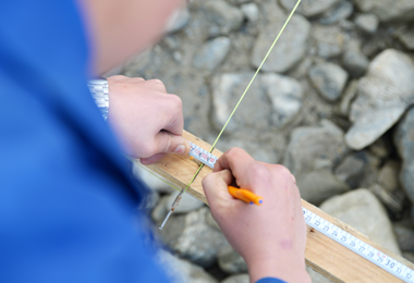 Tradesman with ruler and pencil marking points